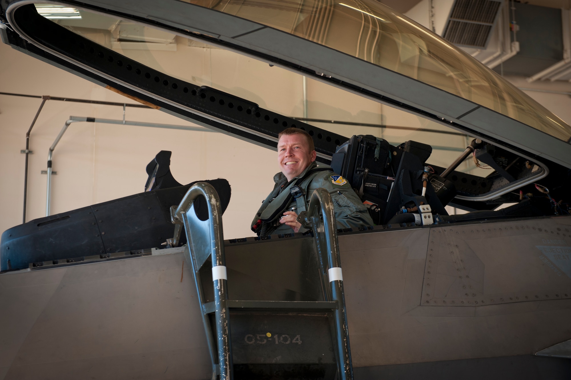 Lieutenant Colonel Shawn Anger, 7th Fighter Squadron commander, enters the cockpit of an F-22 Raptor at Holloman Air Force Base, N.M., Jan. 6. The first five of 24 combat-deployable F-22 Raptors left Holloman heading to Tyndall Air Force Base, Fla. as a permanent change of station. The five F-22s that left Jan. 6 will be followed by six Raptors leaving each month until the move is completed. (U.S. Air Force photo by Airman 1st Class Aaron Montoya)