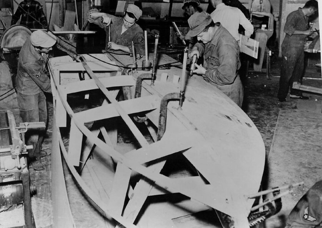 In their off duty time, airmen assemble a rowboat that will be used on a lake near Phoenix, Airzona in 1955. The presence of well equipped hobby shops were a positive morale factor in the Fifteenth Air Force. (Strategic Air Command archives)