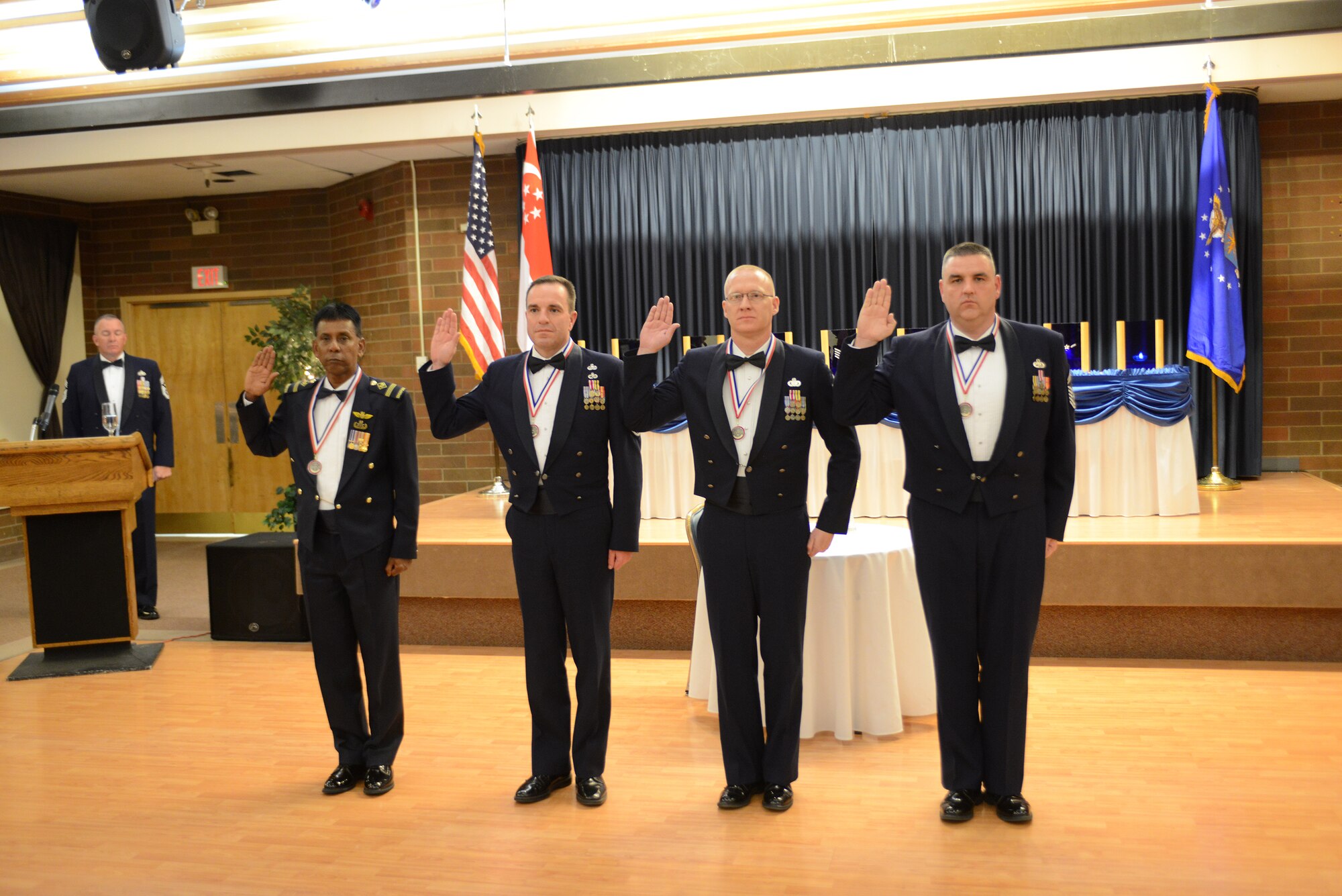 Four Chief Master Sgt. inductees raise their right hands and recite the Chief Master Sgt. oath Jan. 9, 2014, at Mountain Home AIr Force Base, Idaho. As members of the highest enlisted grade in the Air Force, chiefs have been entrusted as good stewards of personnel, equipment and the overall mission. (U.S. Air Force photo by Senior Airman Benjamin Sutton/Released)