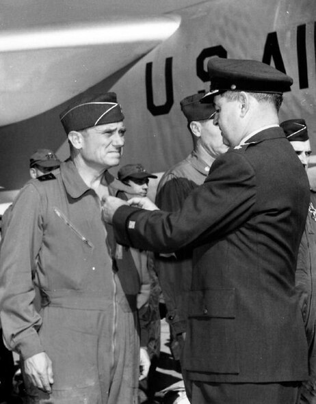 GENERAL CURTIS E. LeMAY, right, pins the Distinguished Flying Cross on Major General Archie J. Old, Jr., at March Air Force Base, California, shortly after the General completed a round-the-world flight in a B-52 on January 18, 1957. (Strategic Air Command Archives)