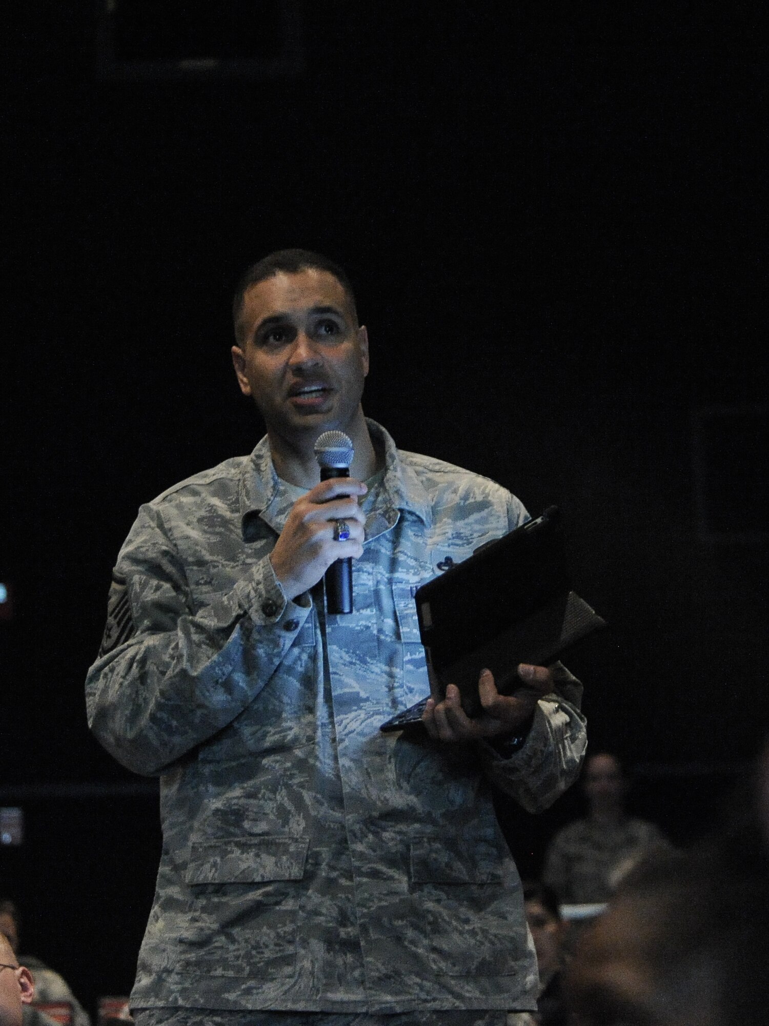 Master Sgt. Michael Roberts, 92nd Civil Engineer first sergeant, relays questions and concerns about the Enlisted Retention Board options from his Airmen through his mobile device during the Enlisted Retention Board town hall at Fairchild Air Force Base, Wash., Jan. 7, 2014. An enlisted retention board will be held in June to consider eligible senior airmen through senior master sergeants for retention in the Air Force. (U.S. Air Force photo by Staff Sgt. Alexandre Montes/RELEASED)