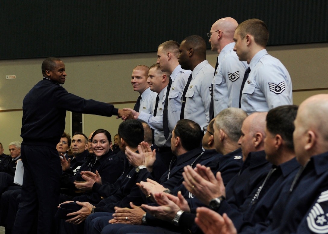 Lt. Gen. Darren W. McDew, 18th Air Force commander, shakes hands with Airmen from the 89th Aerial Port Squadron during a commander's call at Joint Base Andrews, Md., Jan. 7, 2014. The Airmen were being recognized for their actions while deployed, supporting the recovery efforts of the KC-135 Stratotanker crash near Chon-Aryk, Kyrgyzstan by driving the aircraft recovery team more than 700 miles to and from the crash site. (U.S. Air Force photo by/ Airman 1st Class Nesha Humes)