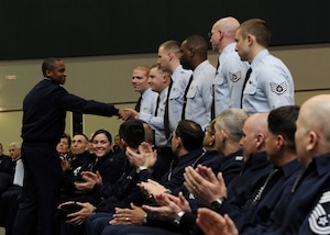 Lt. Gen. Darren W. McDew, 18th Air Force commander, shakes hands with Airmen from the 89th Aerial Port Squadron during a commander's call at Joint Base Andrews, Md., Jan. 7, 2014. The Airmen were being recognized for their actions while deployed, supporting the recovery efforts of the KC-135 Stratotanker crash near Chon-Aryk, Kyrgyzstan by driving the aircraft recovery team more than 700 miles to and from the crash site. (U.S. Air Force photo by/ Airman 1st Class Nesha Humes)