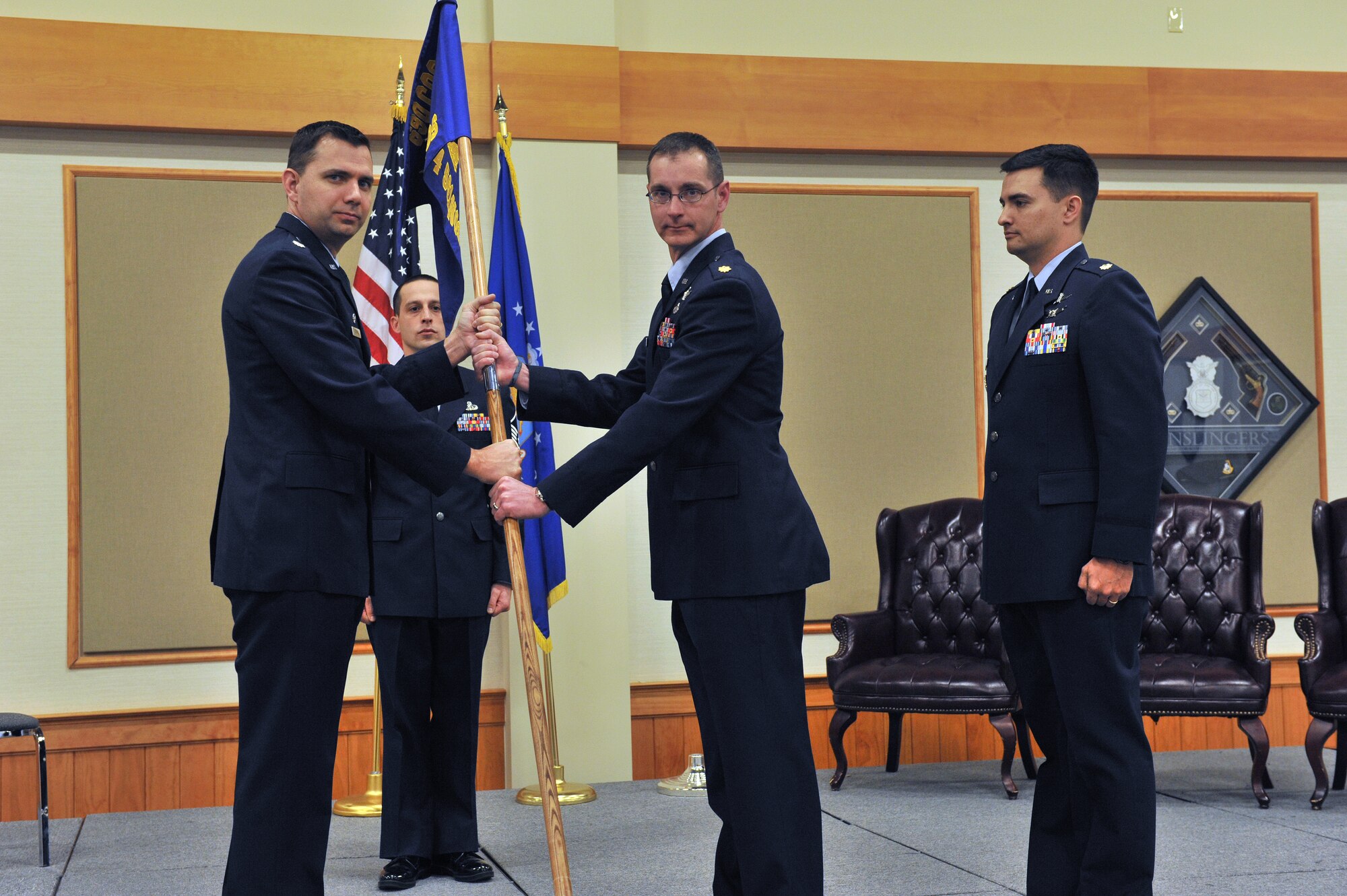 Maj. Terry Daugherty (center) accepts command of the 561st Network Operations Squadron Detachment 4 from Lt. Col. Roy Rockwell, 561st NOS commander (left), during a change of command ceremony Jan. 8.  Maj. Kevin Childs, outgoing commander (right), and Master Sgt. Joshua Gaffney, 561st NOS Det. 4 superintendent, look on.  (U.S. Air Force photo/John Turner)