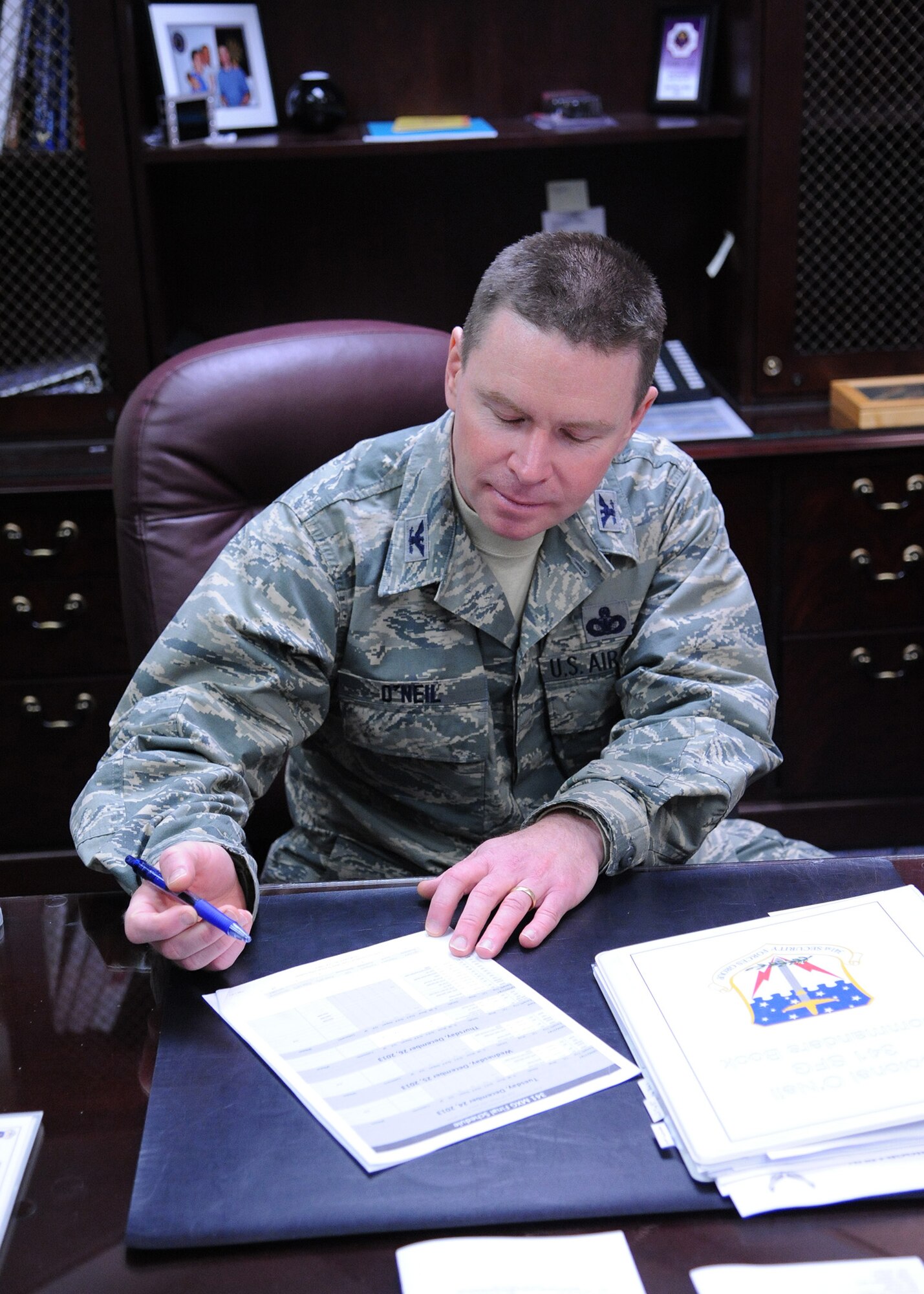 Col. Kenneth O’Neil, 341st Security Forces Group commander, finishes up some paperwork in his office Jan. 2. O’Neil joined Team Malmstrom in November and hopes to inspire his troops to become leaders.  (U.S. Air Force photo/Senior Airman Cortney Paxton)