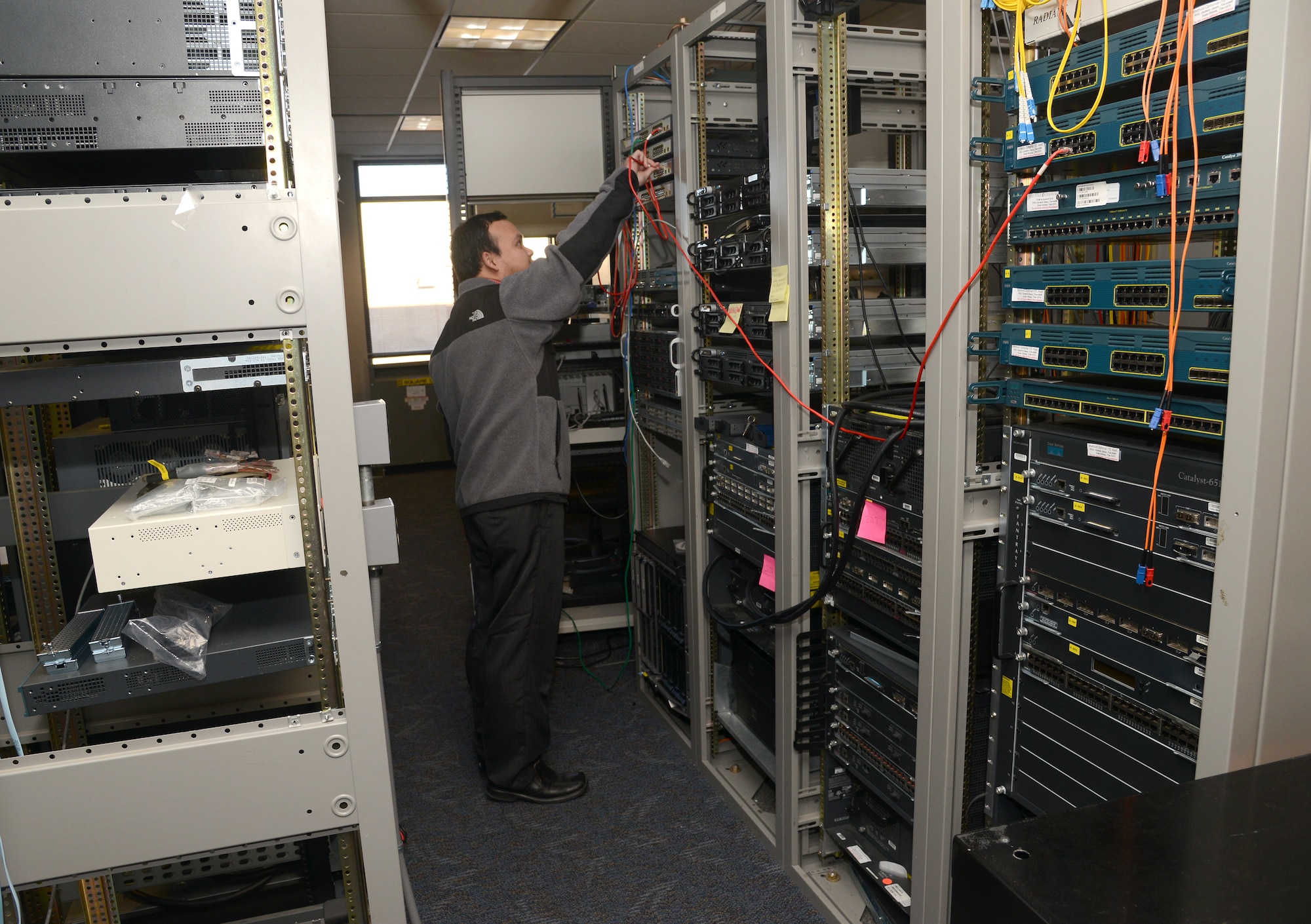 Phu Tran, a system engineer with the 38th Cyberspace Engineering and Installation Group, practices network configurations in a lab setting. Engineers can test different scenarios and systems here at Tinker before they’re even installed in other locations. (Air Force photo by Kelly White)