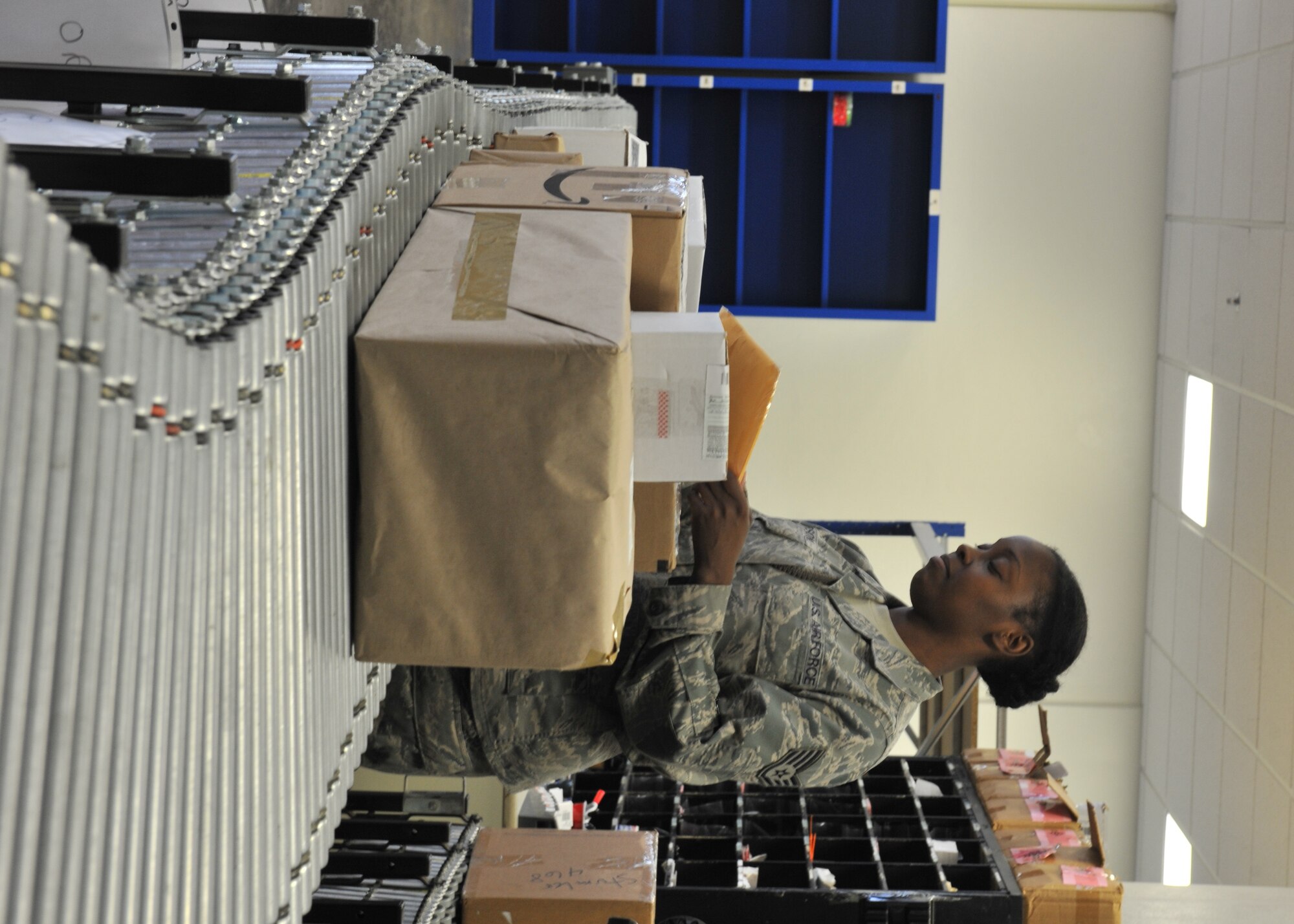 U.S. Air Force Staff Sgt. Keundra Gibson, 65th Communications Squadron custodian of postal effects, sorts packages on the conveyer belt at the Lajes Field Post Office Jan. 9, 2014. The 65th CS Postal Service team was recently awarded the Information Dominance Air Force Outstanding Small Postal Facility Award for 2013. (U.S. Air Force photo by Staff Sgt. Angelique N. Smythe)