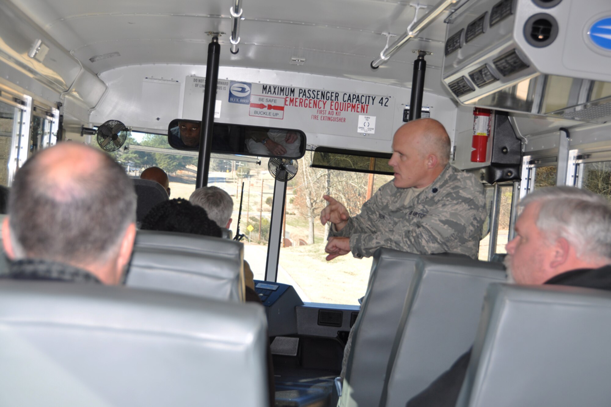 Lt. Col. James Wilson, chief of Public Affairs, conducts a windshield bus tour of Dobbins Air Reserve Base to fourteen Atlanta and Warner Robins area government contracting agency leaders during the quarterly Heads of Contracting Activity meeting Jan. 8. The HCA meeting serves as a platform for Air Force Reserve Command, Warner Robins Air Logistics Complex, Center for Disease Control and Prevention, Housing and Urban Development, Small Business Administration and Dobbins Air Reserve Base chiefs of contracting to discuss resource issues, ideas and best practices. (U.S. Air Force photo/Brad Fallin)