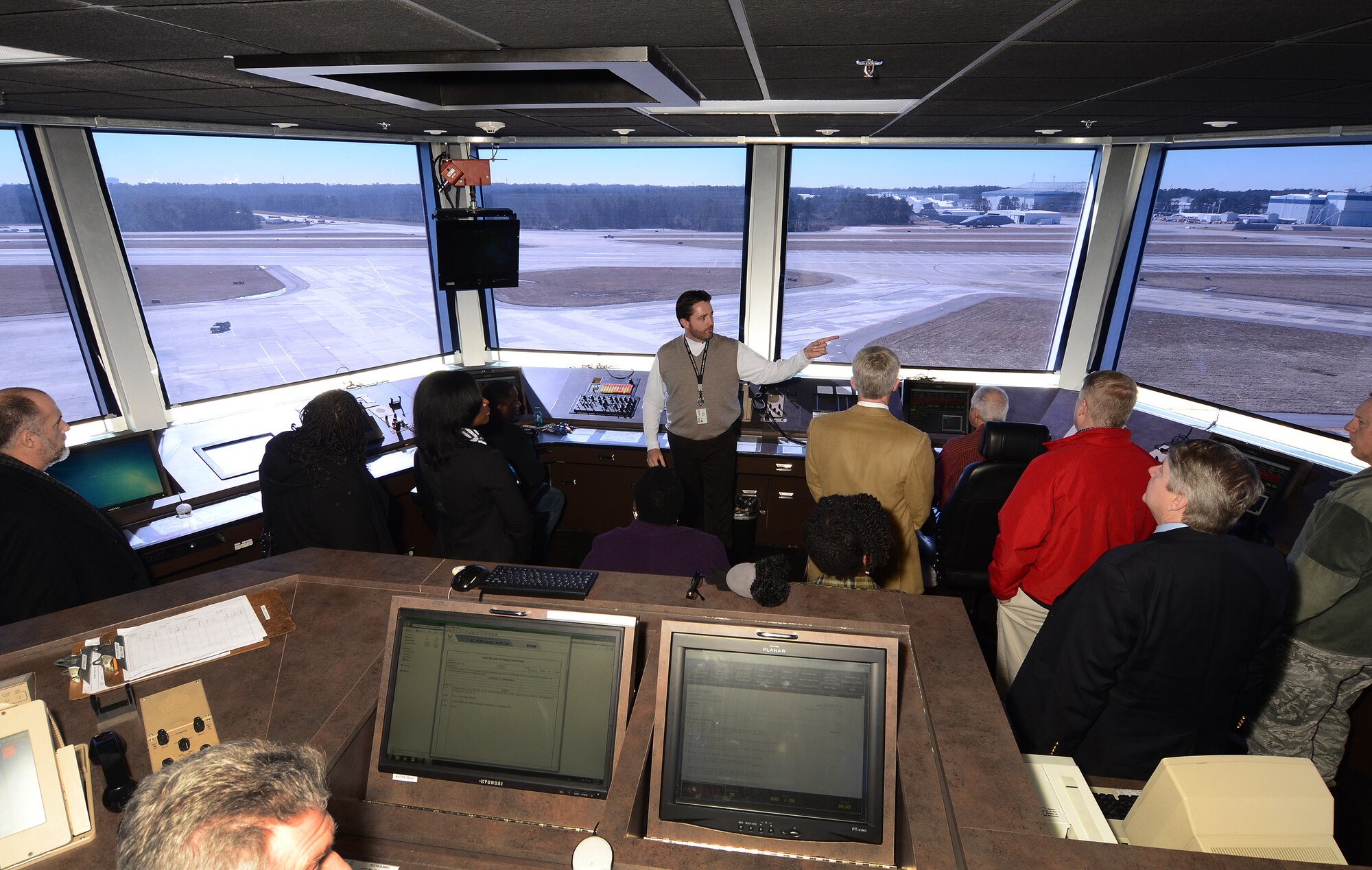 David Seal of the Dobbins Air Traffic Control Tower conducts a tour of the tower to fourteen Atlanta and Warner Robins area government contracting agency leaders during the quarterly Heads of Contracting Activity meeting Jan. 8. The HCA meeting serves as a platform for Air Force Reserve Command, Warner Robins Air Logistics Complex, Center for Disease Control and Prevention, Housing and Urban Development, Small Business Administration and Dobbins Air Reserve Base chiefs of contracting to discuss resource issues, ideas and best practices. (U.S. Air Force photo/Brad Fallin)