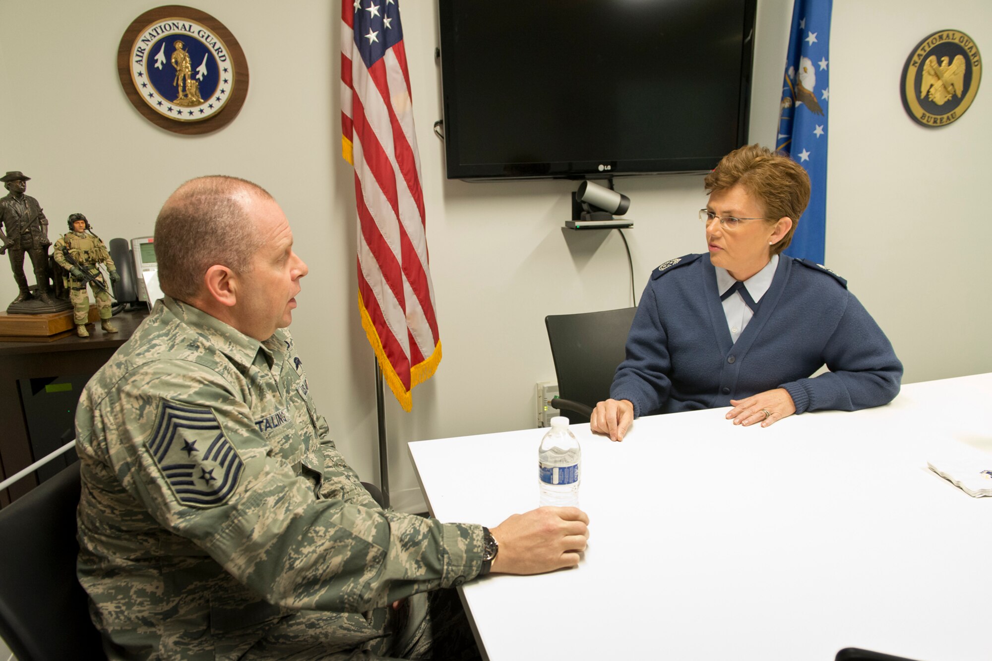 Chief Master Sgt. Victoria Gamble, command chief master sergeant for 18th Air Force, Scott Air Force Base, Ill., visits with Chief Master Sgt. Jim Hotaling, command chief master sergeant of the Air National Guard during an office call at Joint Base Andrews, Md., Jan 7, 2014. As the command chief of 18th AF, Gamble serves as the primary adviser to the commander on matters concerning mission effectiveness, readiness, training, health welfare, and morale of personnel assigned to the command's 11 wings, the 618th Tanker Airlift Control Center, and two stand-alone groups. (U.S. Air National Guard photo by Master Sgt. Marvin R. Preston/Released)