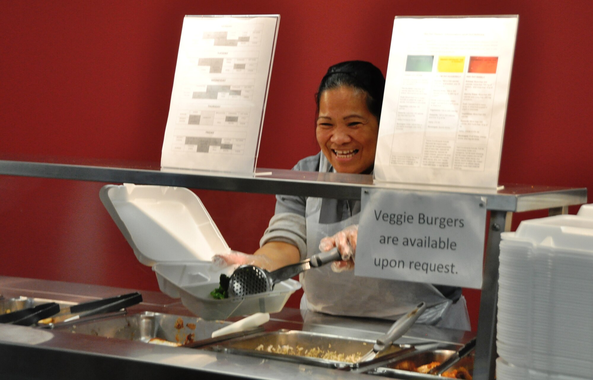 Mrs. Susan Schell, 325th Force Support Squadron food service technician, prepares to serve Airmen visiting the Raptor Quick Turn flight line dining facility Jan. 9. (U.S. Air Force photo by Airman 1st Class Sergio Gamboa)