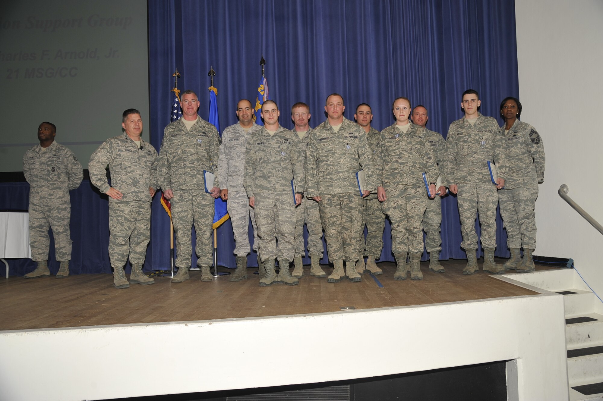 PETERSON AIR FORCE BASE, Colo. - Nine Airmen from the 21st Civil Engineer Squadron received the Air Force achievement medal for their efforts removing several thousand cubic yards of earth and tons of rock from the north portal entrance of Cheyenne Mountain Air Force Station, during a ceremony at the base auditorium Dec. 18. The 21st CES Airmen worked as a joint team with Soldiers from Fort Carson to clear a usable roadway into the mountain within 48 hours of beginning the cleanup. (U.S. Air Force Photo/Robb Lingley).