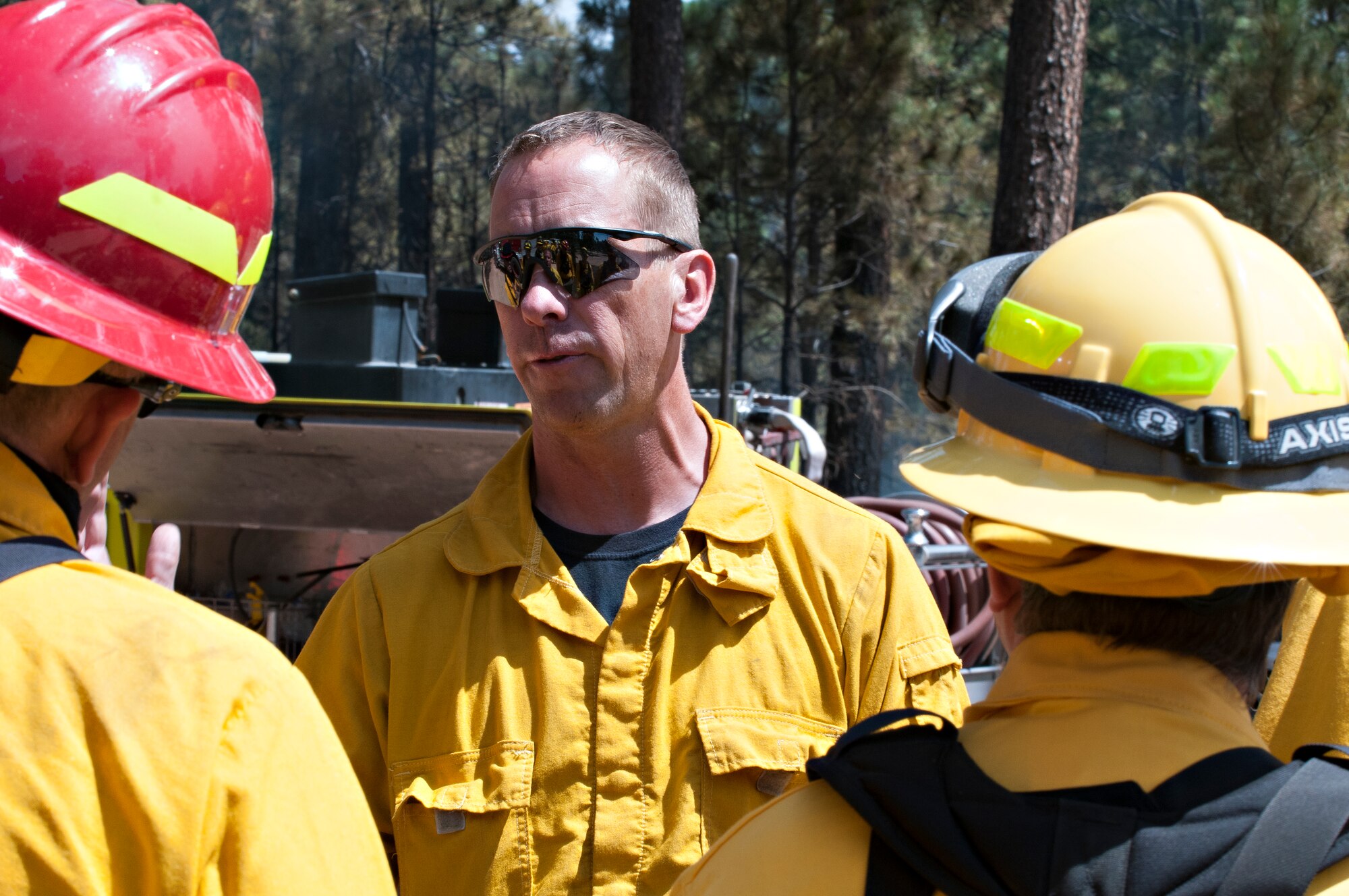 U.S. Air Force Academy 10th Civil Engineer Squadron fire chief Ken Helgerson speaks with other firefighters at the site of the Black Forest fire in June 2013. (Air Force photo/Chris Dewitt)
