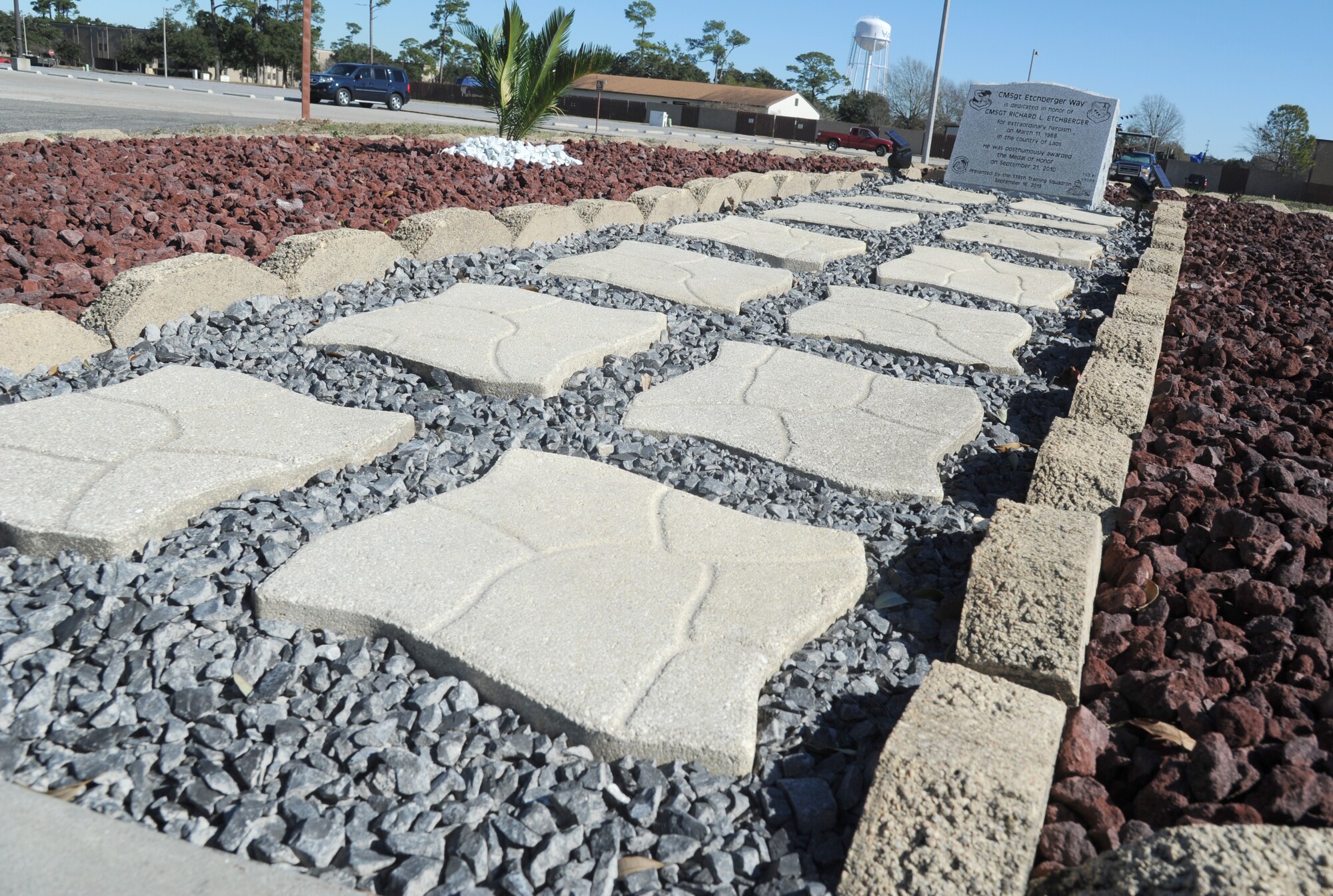 The Chief Master Sgt. Richard Etchberger monument, located on the corner of Hangar Road and CMSgt. Etchberger Way, now sits on display inside a landscaped area Jan. 8, 2014, after receiving a facelift from members of the 338th Training Squadron at Keesler Air Force Base, Miss.  The monument and CMSgt. Etchberger way sign were unveiled during a street dedication ceremony that took place Sept. 16, 2013. (U.S. Air Force photo by Kemberly Groue)
