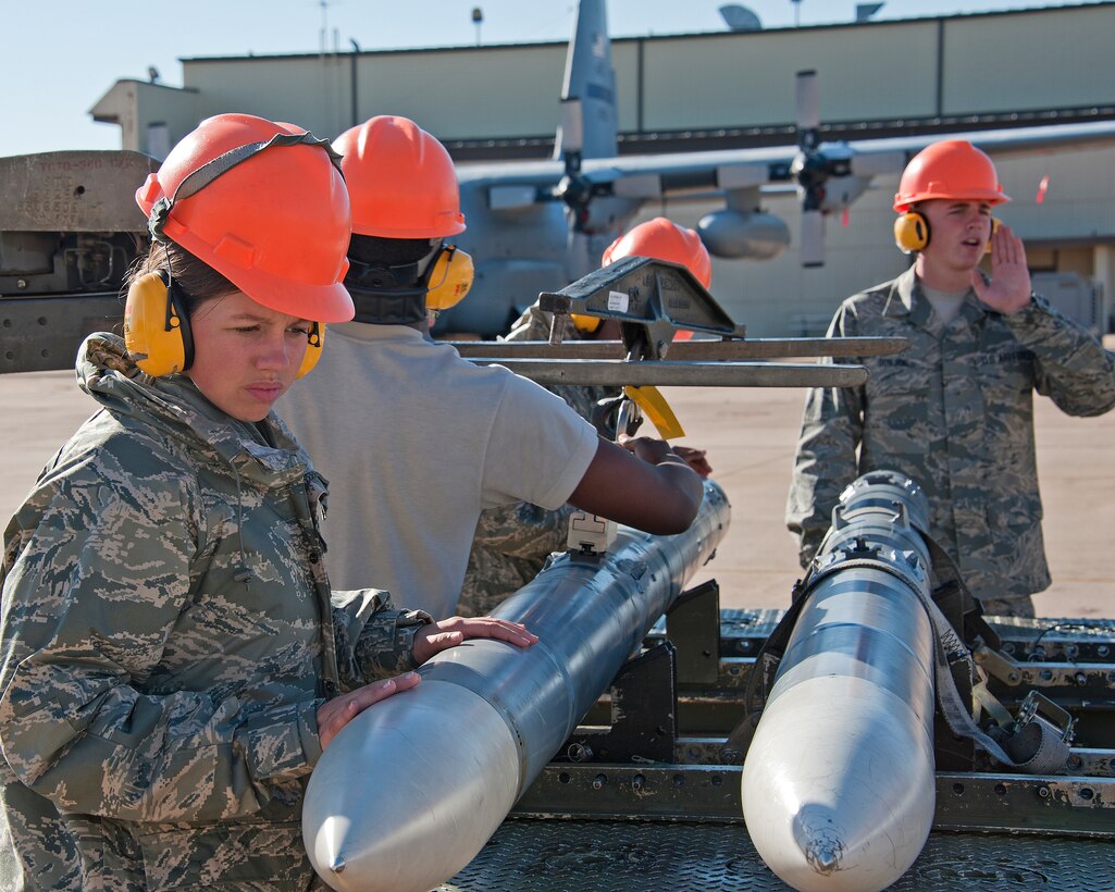 U.S. Air Force Airmen Megan Solan inspects AIM-120 munitions as Airman 1st Class Preston Donjon calls out a next step in the loading of an MHU-141 trailer, 363rd Training Squadron, Munitions Apprentice course on October 17, 2013 at Sheppard Air Force Base, Texas. (U.S. Air Force photo by Frank Carter/Released)
