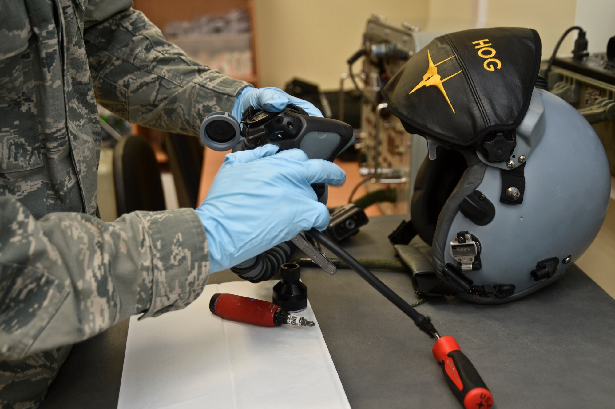 Senior Airman Jeffery Berry, 493rd Expeditionary Fighter Squadron aircrew flight equipment journeyman, works on a deluder valve for a helmet at the Quick Reaction Alert facility at Šiauliai Air Base, Lithuania, Jan. 7, 2014. Equipment is modified to fit each aircrew member properly, helping to prevent injury during ejection and minimizing distractions, allowing pilots to support the mission as safely as possible.  (U.S. Air Force photo by Airman 1st Class Nigel Sandridge /Released)