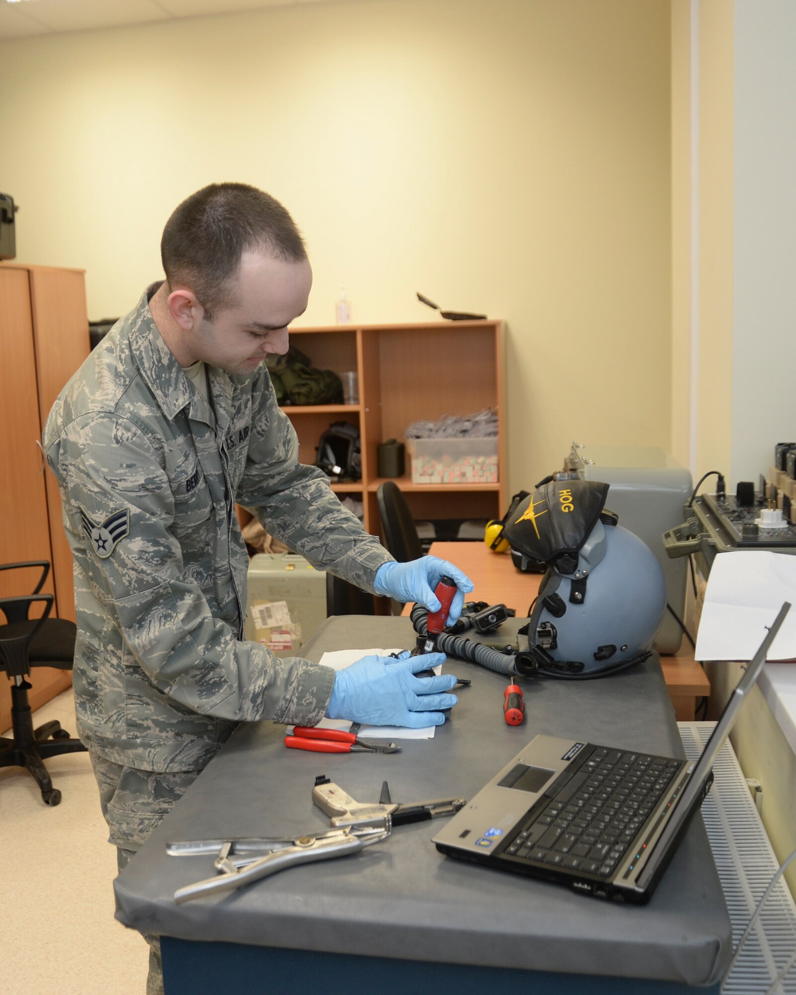 Senior Airman Jeffery Berry, 493rd Expeditionary Fighter Squadron aircrew flight equipment journeyman, prepares for a helmet fitting at the Quick Reaction Alert facility at Šiauliai Air Base, Lithuania, Jan. 7, 2014. Equipment is modified to fit each aircrew member properly, helping to prevent injury during ejection and minimizing distractions, allowing pilots to support the mission as safely as possible. (U.S. Air Force photo by Airman 1st Class Nigel Sandridge /Released)