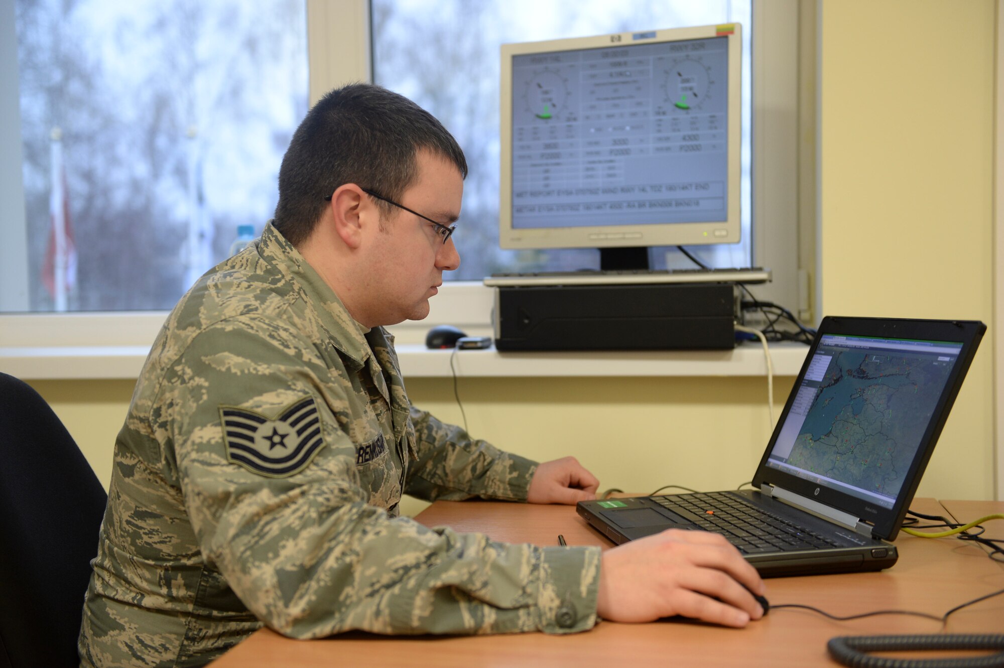 Tech. Sgt. Matthew Renkosiak, 48th Air Expeditionary Group weather forecaster, monitors weather patterns using various computer-generated models at Siauliai Air Base, Lithuania, Jan. 7, 2014. Renkosiak is the sole weather forecaster deployed with the 48th AEG and will work closely with the Lithuanian meteorology office at Siauliai Air Field.  (U.S. Air Force Photo by 1st Lt. Leah Davis/Released)