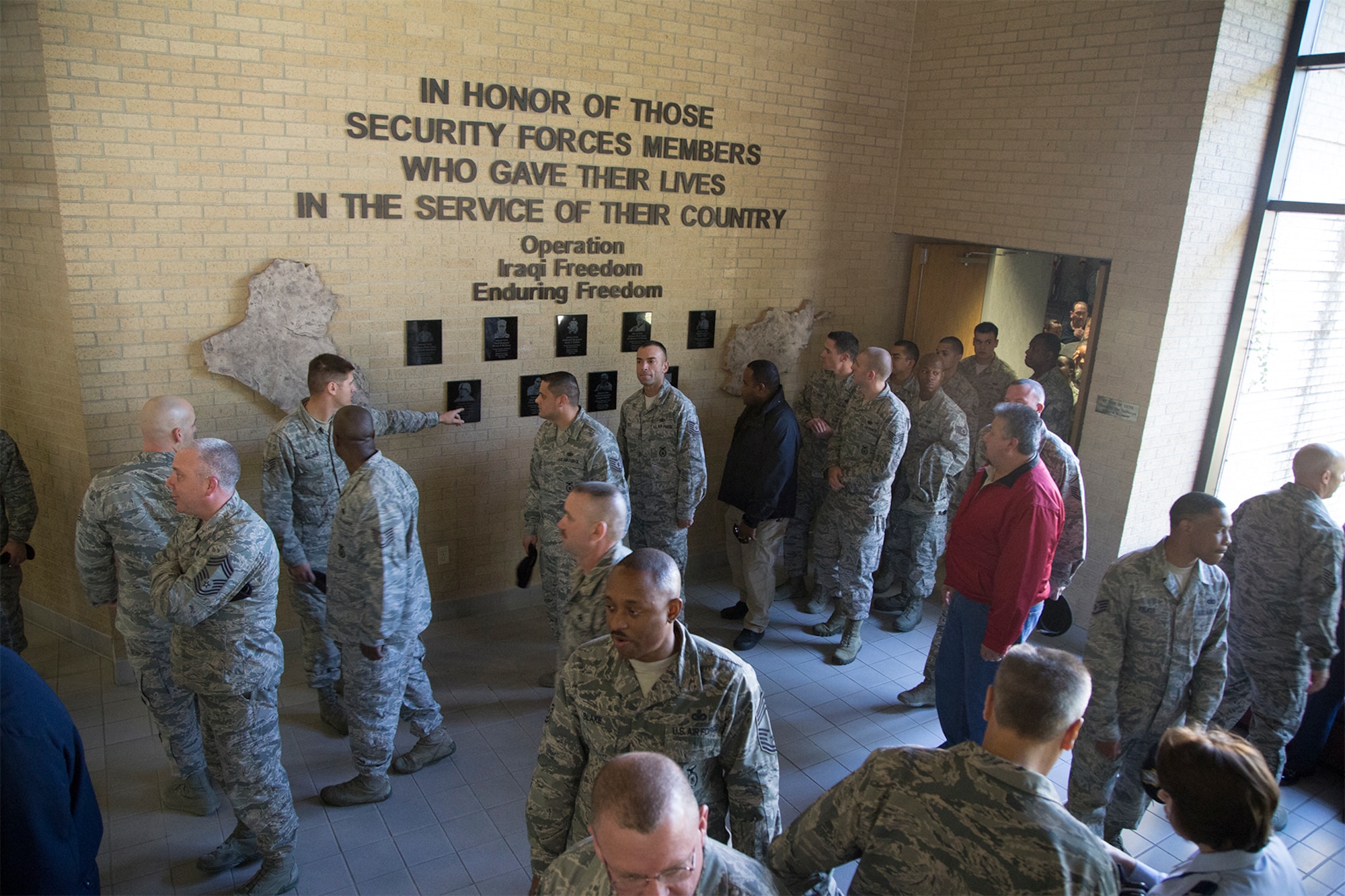 The memorial wall at the 343rd Traininag Squadron honors Air Force Security Forces members who have fallen in recent conflicts. It also serves as a solemn reminder about the realities of the oath the newest Security Forces Airmen take. (U.S Air Force Photo/Joshua Rodriguez)