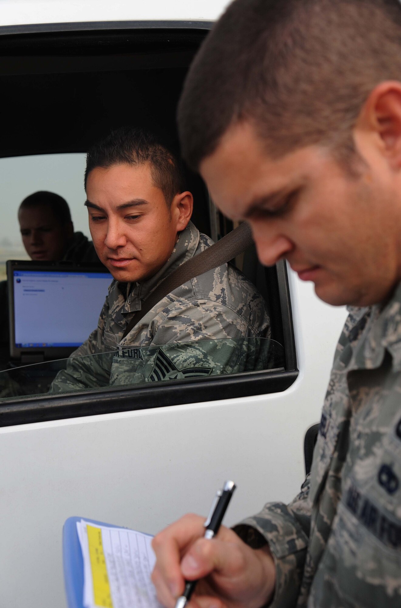 Tech. Sgt. Travis Trussell, 386th Expeditionary Operations Support Squadron, inspects the credentials of Tech. Sgt. Robert Rossi, 386th Expeditionary Maintenance Group, during a 483 spot check on the flight line at an undisclosed location in Southwest Asia. Trussell is a deputy airfield manager deployed from Scott Air Force Base and a native of Walkerville, MI and Rossi is a C130J expeditor deployed from Quonset Point, RI and is a native of Warwick, RI.  (U.S. Air Force photo by Senior Airman Desiree W. Moye) 