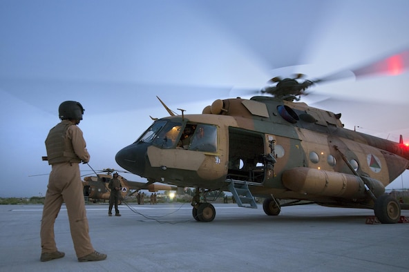 An Afghan Air Force aerial gunner communicates Mi-17 helicopter preflight checks to his pilot under early morning moonlight at Jalalabad Airfield, Afghanistan, on the first day of Operation Seemorgh, July 23, 2013. Operation Seemorgh, named after a mythical bird, is the largest Afghan-led combat operation in more than 30 years, combining air and ground forces in an offensive focused on Taliban in Loghar Province. (U.S. Air Force Photo/Master Sgt. Ben Bloker) 