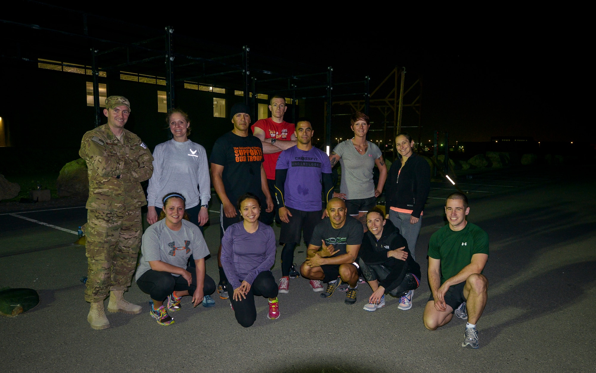 Coaches and attendees pose for a group photo after a Crossfit Undisclosed workout Jan. 8, 2014 at Al Udeid Air Base Qatar. Crossfit Undisclosed, which was started in May 2013, hosts four classes a day and provides service members stationed here an alternative to a mundane workout routine.  (U.S. Air Force photo/Senior Airman Jared Trimarchi)