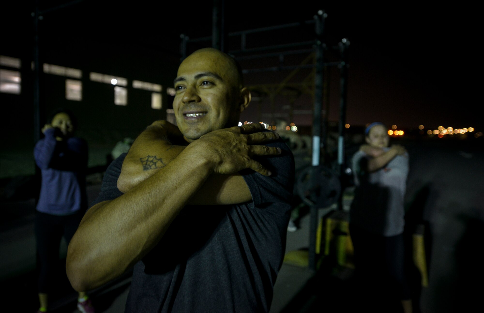 Army Chief Warrant Officer 3 Abel Almanza stretches his tricep after a Crossfit Undisclosed workout Jan. 8, 2014 at Al Udeid Air Base Qatar. Crossfit Undisclosed, which was started in May 2013, hosts four classes a day and provides service members stationed here an alternative to a mundane workout routine. Almanza is a targeting officer from the 41st Fires Brigade who is deployed from Ft. Hood, Texas and an Oceanside, Calif. native.  (U.S. Air Force photo/Senior Airman Jared Trimarchi)
