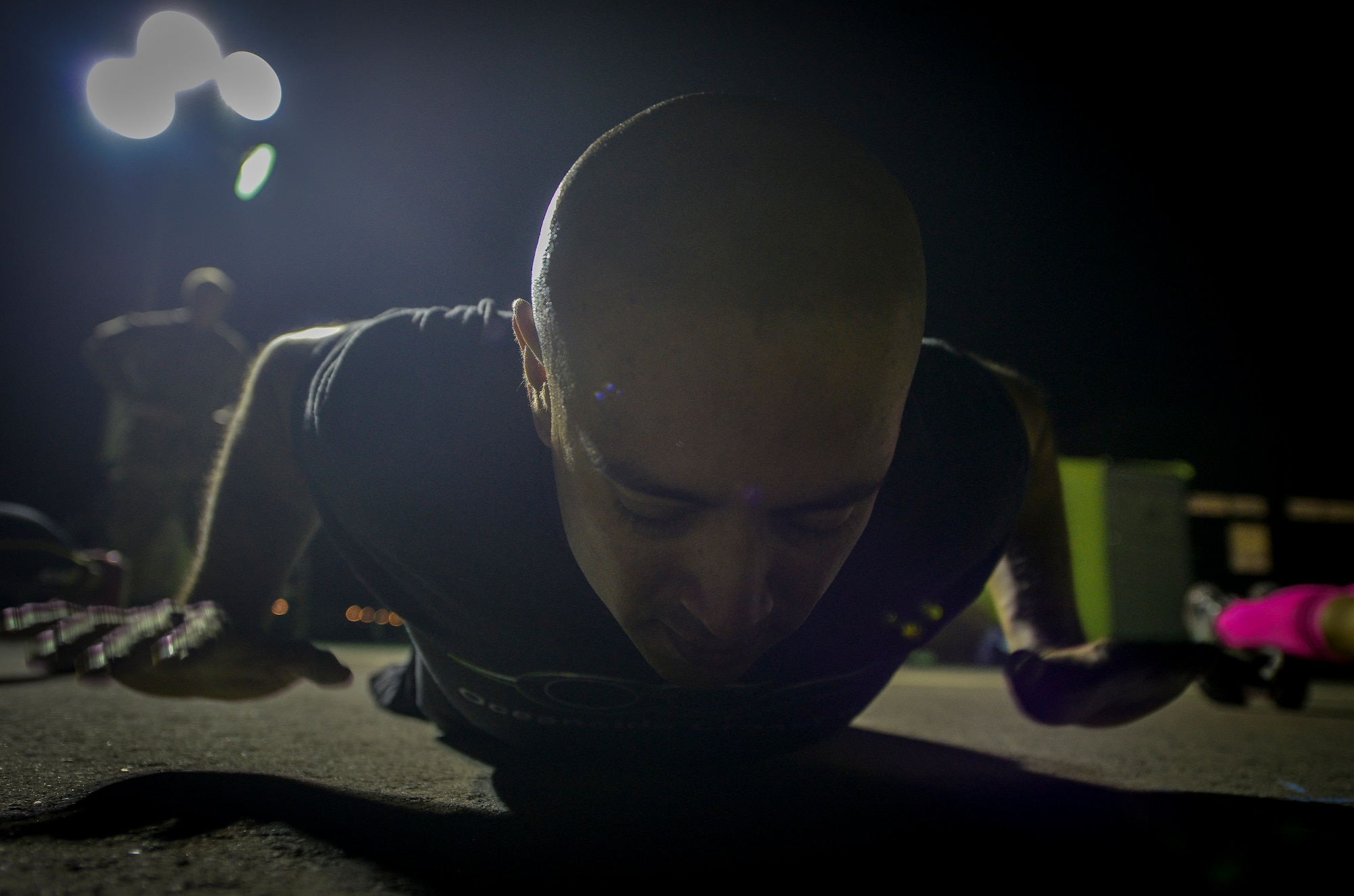 Army Chief Warrant Officer 3 Abel Almanza performs a hand release pushup during a Crossfit Undisclosed workout Jan. 8, 2014 at Al Udeid Air Base Qatar. Crossfit Undisclosed, which was started in May 2013, hosts four classes a day and provides service members stationed here an alternative to a mundane workout routine. Almanza is a targeting officer from the 41st Fires Brigade who is deployed from Ft. Hood, Texas and an Oceanside, Calif. native.  (U.S. Air Force photo/Senior Airman Jared Trimarchi)