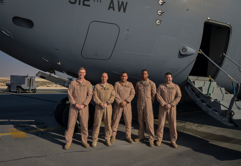 Airmen from the 816th Expeditionary Airlift Squadron pose for a group photo in front of a C-17 Globemaster III at Al Udeid Air Base, Qatar, Jan. 9, 2014. The 816th EAS is responsible for providing strategic airlift and combat operations to the U.S. Air Forces Central Command’s area of responsibility. The Airmen assigned to the 816th EAS, who are deployed from Joint Base Charleston, S.C., have flown more than130 sorties, moved more than 4 million pounds of cargo and more than 1,700 passengers in the past two weeks alone. (U.S. Air Force photo/Senior Airman Jared Trimarchi) 