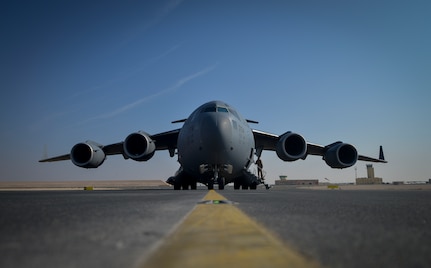 A C-17 Globemaster III sits on a flightline at Al Udeid Air Base, Qatar, Jan. 9, 2014. The C-17 is assigned to the 816th Expeditionary Airlift Squadron which is responsible for providing strategic airlift and combat operations to the U.S. Air Forces Central Command’s area of responsibility. The Airmen assigned to the 816th EAS, who are deployed from Joint Base Charleston, S.C., have flown more than130 sorties, moved more than 4 million pounds of cargo and more than 1,700 passengers in the past two weeks alone. (U.S. Air Force photo/Senior Airman Jared Trimarchi) 