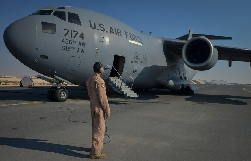 Senior Airman Don Dutton from Al Udeid Air Base, Qatar,  performs an engine check with a pilot of a C-17 Globemaster III before taking off on a mission to Kandahar, Afghanistan Jan. 9, 2014. The 816th EAS is responsible for providing strategic airlift and combat operations to the U.S. Air Forces Central Command’s area of responsibility. The Airmen assigned to the 816th EAS, who are deployed from Joint Base Charleston, S.C., have flown more than130 sorties, moved more than 4 million pounds of cargo and more than 1,700 passengers in the past two weeks alone. Dutton is a loadmaster who hails from Sacramento, Calif. (U.S. Air Force photo/Senior Airman Jared Trimarchi) 