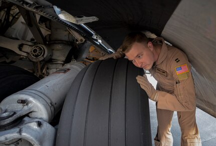 At Al Udeid Air Base, Qatar, Capt. Philip Bush inspects the landing gear of a C-17 Globemaster III before taking off on a mission to Kandahar, Afghanistan Jan. 9, 2014. The 816th EAS is responsible for providing strategic airlift and combat operations to the U.S. Air Forces Central Command’s area of responsibility. The Airmen assigned to the 816th EAS, who are deployed from Joint Base Charleston, S.C., have flown more than130 sorties, moved more than 4 million pounds of cargo and more than 1,700 passengers in the past two weeks alone. Bush is a pilot who hails from Lockhart, Texas. (U.S. Air Force photo/Senior Airman Jared Trimarchi) 