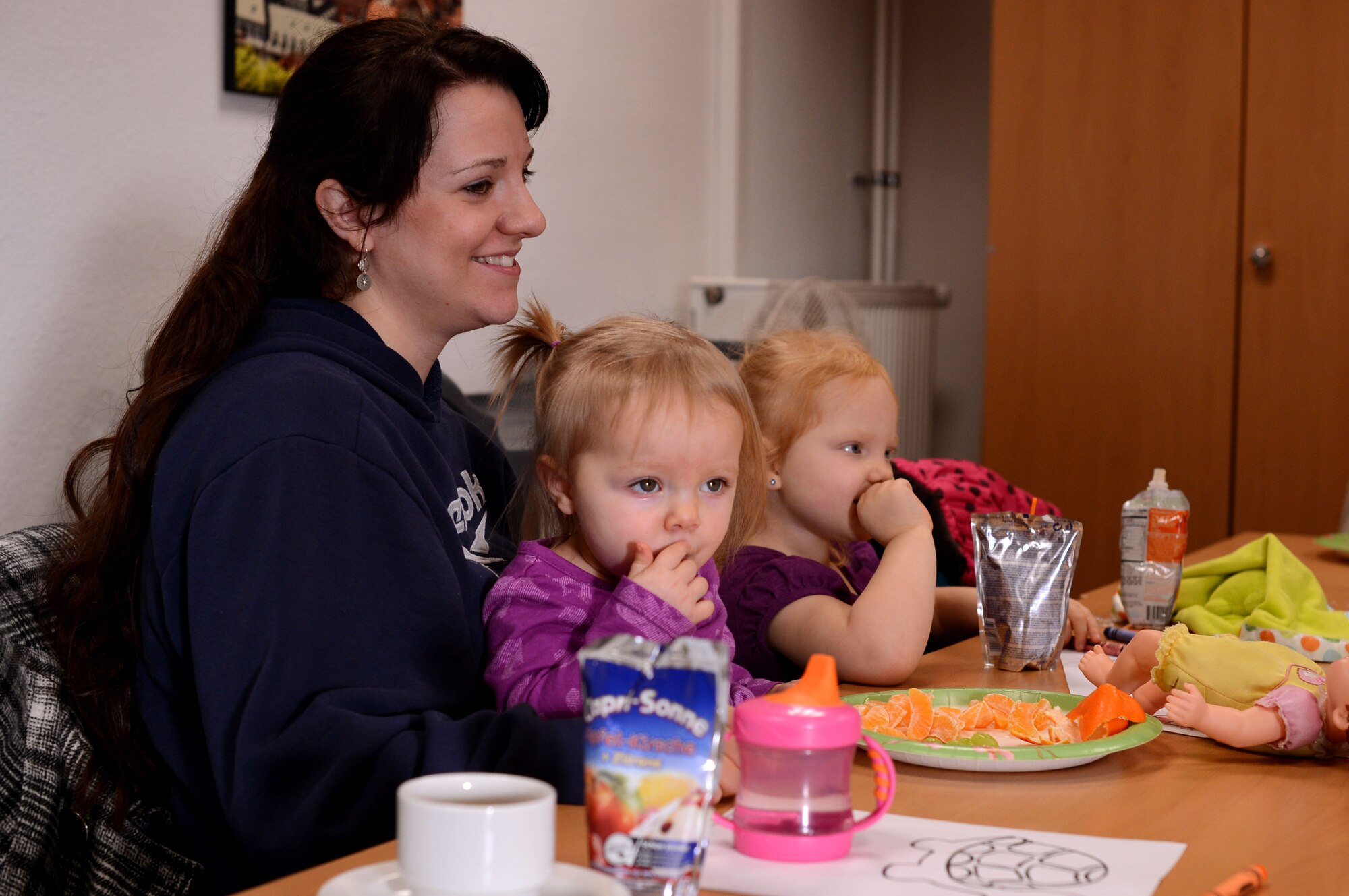 SPANGDAHLEM AIR BASE, Germany – Amy Crist sits with her two children, Audriana and Alayna, during a community coffee break at the 52nd Force Support Squadron Airman & Family Readiness Center Jan. 10, 2014. The coffee break allowed the opportunity to meet new people and talk about current events. (U.S. Air Force photo by Airman 1st Class Kyle Gese/Released)