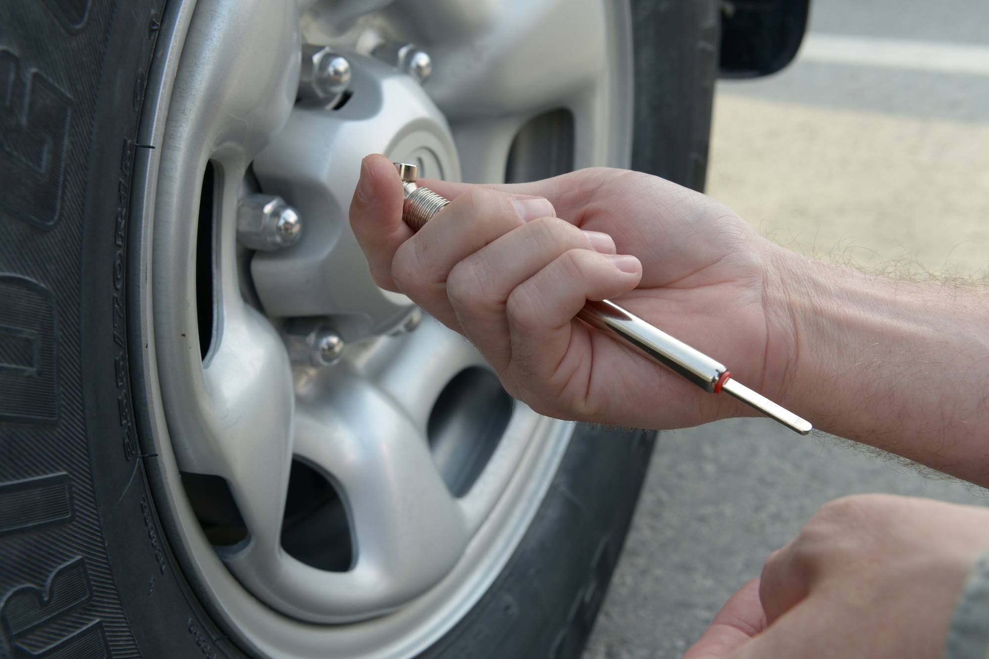 Staff Sgt. Dustin Roberts a 379th Air Expeditionary Wing Public Affairs broadcaster reads the  tire presser gauge at Al Udeid Air Base, Qatar, Jan. 10, 2014. Tire pressure must be checked once a month within the first 10 days of the month and turned into the vehicle control officer. Vehicle control officers are appointed by unit commanders to be the focal point concerning vehicle assets and acts as the liaison between the unit and vehicle management. Roberts is deployed from Anderson Air Force Base, Guam, and hails from Tifton, Ga. (U.S. Air Force photo/Senior Airman Hannah Landeros)