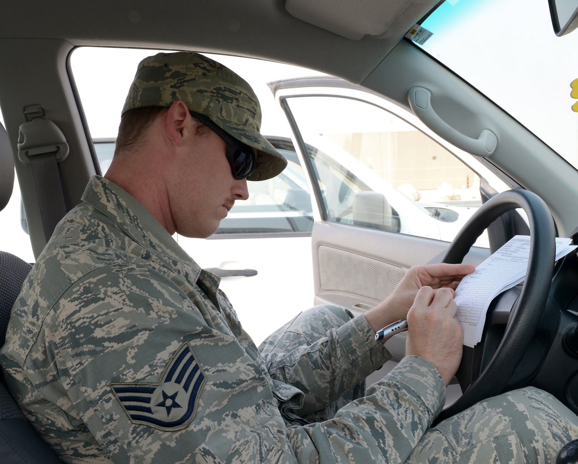 Staff Sgt. Dustin Roberts a 379th Air Expeditionary Wing Public Affairs broadcaster signs an Air Force Form 1800 at Al Udeid Air Base, Qatar, Jan. 10, 2014.Air Force Form 1800s must be signed daily by the vehicle operator, or every seven days if not driven daily and turned into the vehicle control officer. Vehicle control officers are appointed by unit commanders to be the focal point concerning vehicle assets and acts as the liaison between the unit and vehicle management. Roberts is deployed from Anderson Air Force Base, Guam, and hails from Tifton, Ga. (U.S. Air Force photo/Senior Airman Hannah Landeros)