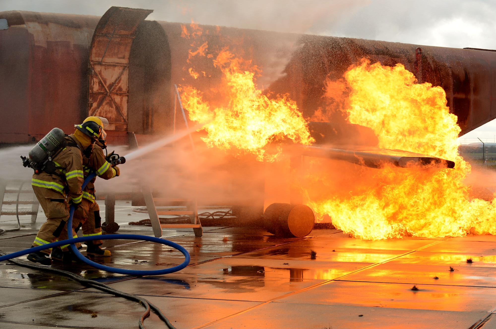 SPANGDAHLEM AIR BASE, Germany – U.S. Air Force firefighters suppress an engine and fuel fire during a live-fire training exercise Jan. 8, 2014. This training prepared Airmen for real-world scenarios and kept them qualified for their annual requirements. (U.S. Air Force photo by Airman 1st Class Kyle Gese/Released)