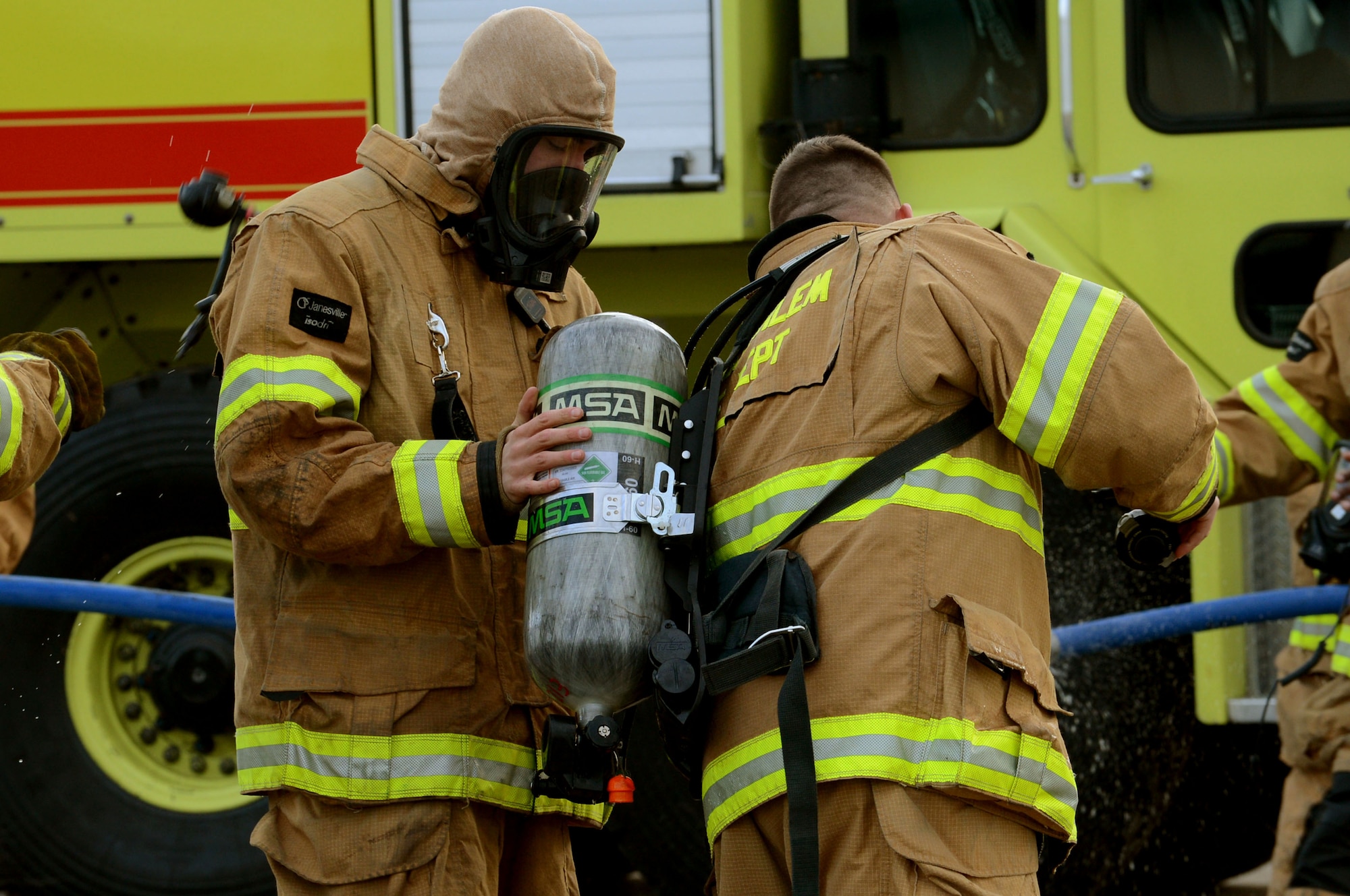 SPANGDAHLEM AIR BASE, Germany – U.S. Air Force firefighters gear up for a live-fire training exercise on the burn pad Jan. 8, 2014. The fire department completed nine days of live burns in January to reach their mission objective of keeping everyone qualified. (U.S. Air Force photo by Airman 1st Class Kyle Gese/Released)