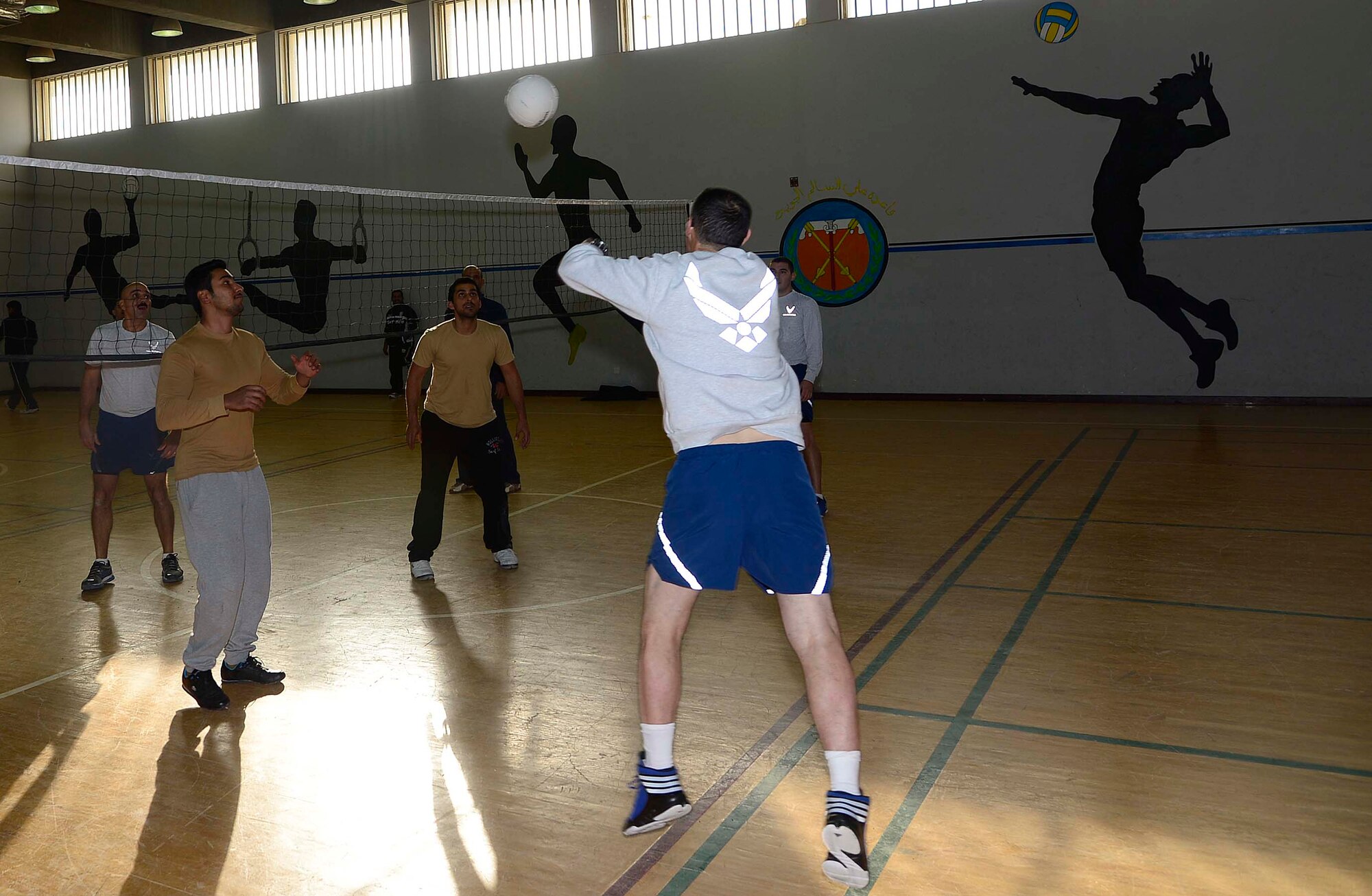 Airmen from the 386th Air Expeditionary Wing met their host-nation counterparts for a friendly game of volleyball on Tuesday at an undisclosed location in Southwest Asia. The game was part of a new Sports Day initiative, created by host-nation senior leadership, which enables deployed U.S. service members the opportunity to interact with their counterparts in an informal setting. (U.S. Air Force photo by Senior Airman Desiree W. Moye)