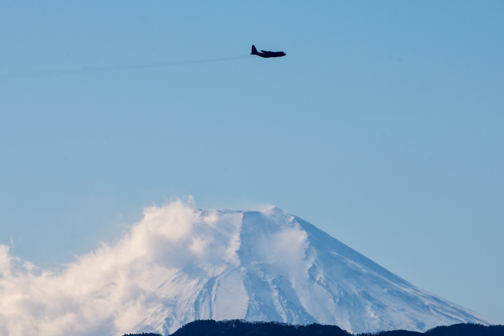 A C-130 Hercules with the 36th Airlift Squadron flies over Yokota Air Base, Japan, during a routine sortie Jan. 9, 2014. After completing missions in Bangladesh, Philippines and Guam, the 36 AS regularly conducts training missions to remain proficient in the necessary skills to support any contingency. (U.S. Air Force photo by Osakabe Yasuo/RELEASED)