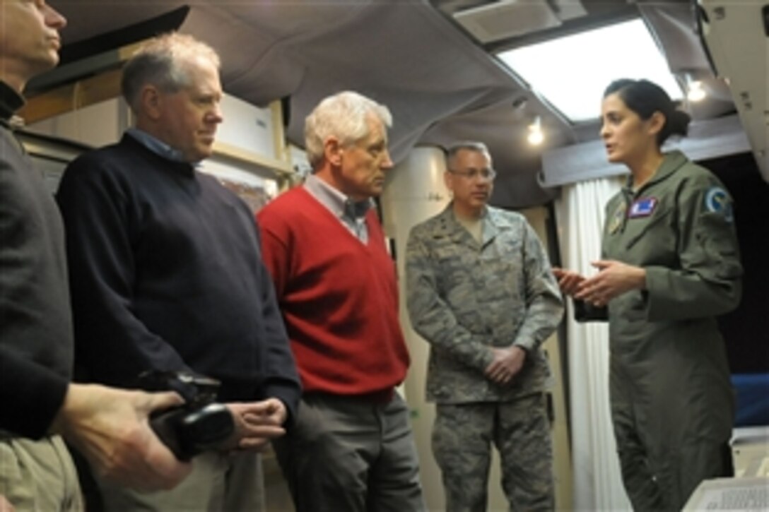 Defense Secretary Chuck Hagel, center, listens as Air Force Capt. Erin Gentile, missile combat crew commander, describes her duties as he visits the E-01 Missile Alert Facility and Launch Control Center near Cheyenne, Wyo., Jan. 9, 2014. 
