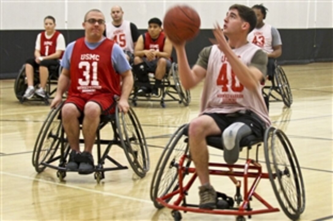 Marine Corps Lance Cpl. Wayne Damron and Cpl. Matthew Miller participate in a scimmage match during the Wounded Warrior Regiment Wheelchair Basketball Camp at the University of Central Florida in Orlando, Fla., Jan. 9, 2014. The Warrior Athlete Reconditioning Program provides opportunities for wounded, ill or injured Marines to train as athletes while increasing their strength to continue with military service. Damron and Miller are assigned to Detachment San Antonio Military Medical Center.