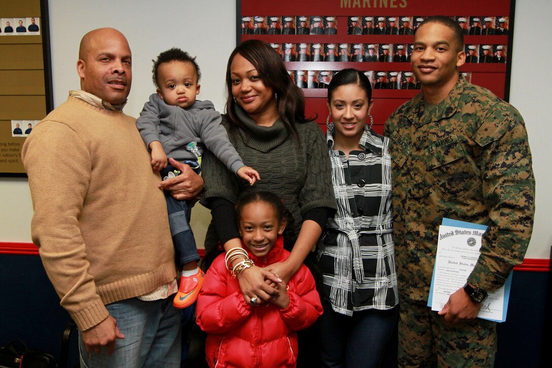 Staff Sgt. Darnell Gervais, the staff noncommissioned officer-in-charge of Recruiting Substation Waterbury, Recruiting Station Springfield, poses for a photo with his family after being meritoriously promoted to the rank of staff sergeant, Jan. 7.  Gervais was one of seven sergeants selected for meritorious promotion across the 1st Marine Corps District.  (U.S. Marine Corps photo by Sgt. Richard Blumenstein).
