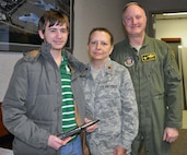 Maj. Jennier L. Burgett, 442nd Fighter Wing Equal Opportunity Officer (center), poses with her son, Devin Burgett,  and 442 FW vice-commander Col. Gregory Eckfeld (right), during a tour  here on Jan. 11, 2014. The Black and Veatch Explorers Post toured the 442nd FW, and got to get up-close-and-personal with the A-10 Thunderbolt II aircraft. The 442nd Fighter Wing is an A-10 Thunderbolt II Air Force Reserve unit at Whiteman Air Force Base, Mo. (U.S. Air Force Photo/Staff Sgt. Wesley Wright)