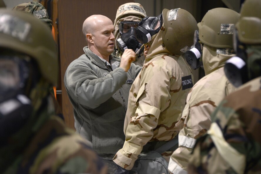 SSgt. Mike Dowling, 175th Emergency Management, checks the Mission Oriented Protective Posture (MOPP) equipment of members from the 175th Aircraft Maintenance Squadron. They were participating in Ability to Survive and Operate training at Warfield Air National Guard Base, Baltimore, MD, January 11, 2014. (Air National Guard Photo by Master Sgt. Gareth Buckland/RELEASED)