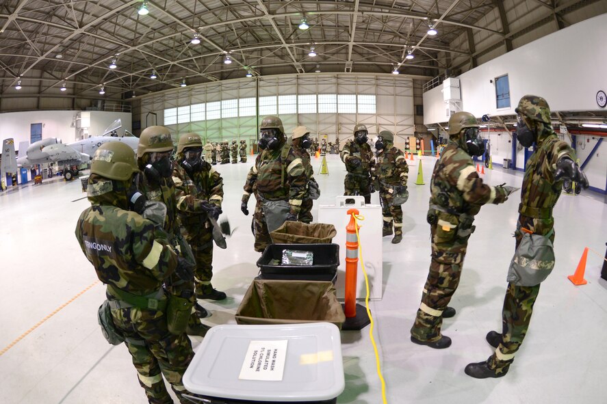 Members of the 175th Aircraft Maintenance Squadron process through a decontamination transition zone. They were participating in Ability to Survive and Operate training at Warfield Air National Guard Base, Baltimore, MD, January 11, 2014. (Air National Guard Photo by Tech. Sgt. Christopher Schepers/RELEASED)