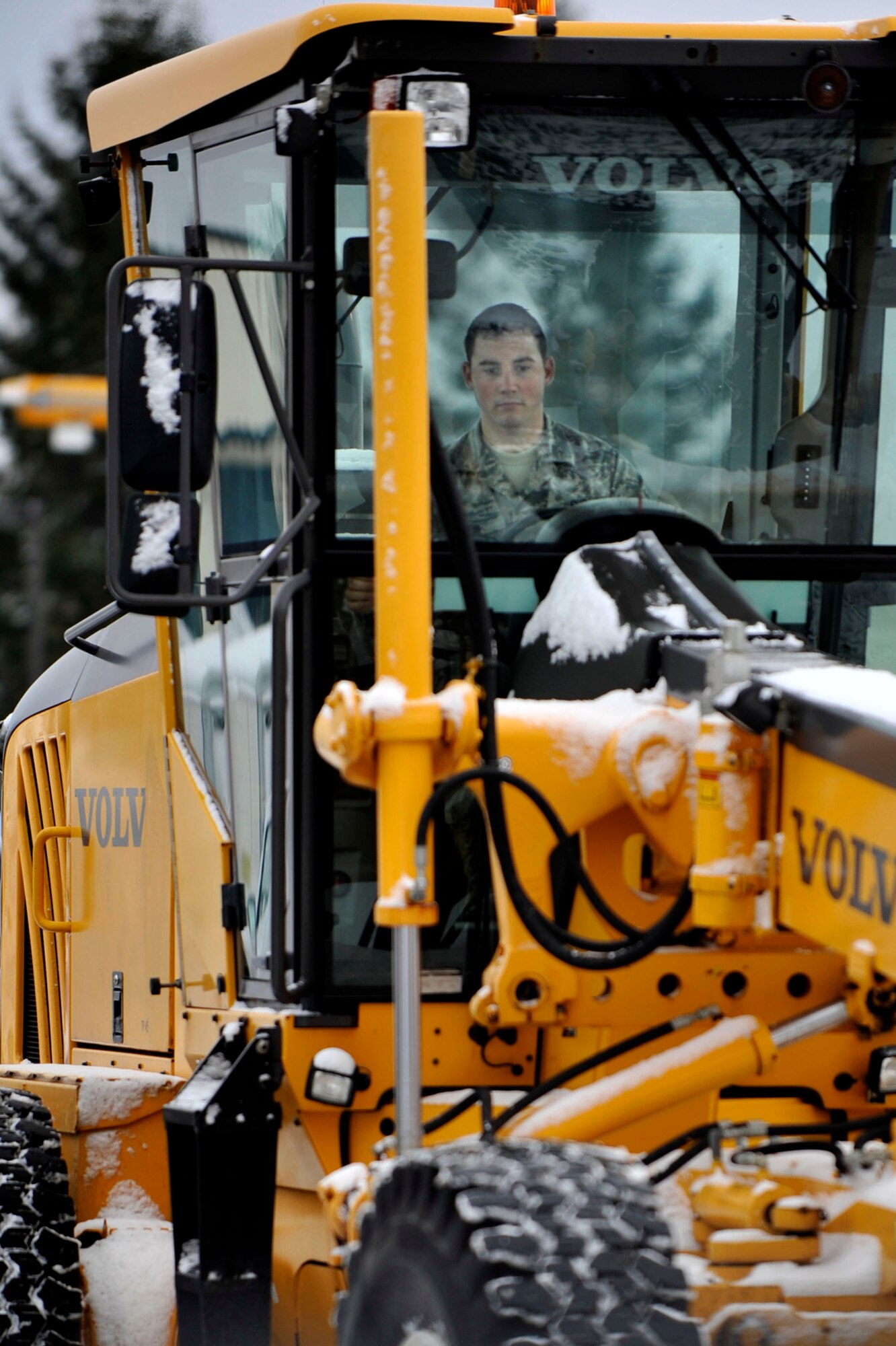 Airman 1st Class William D. Klein, 35th Civil Engineer Squadron pavement and construction equipment apprentice, operates a heavy equipment grader at Misawa Air Base, Japan, Jan. 09, 2014. Each day of snowfall the 35 CES snow removal team plows more than 70 miles of base roadway. Misawa averages 125 inches of snowfall each year.