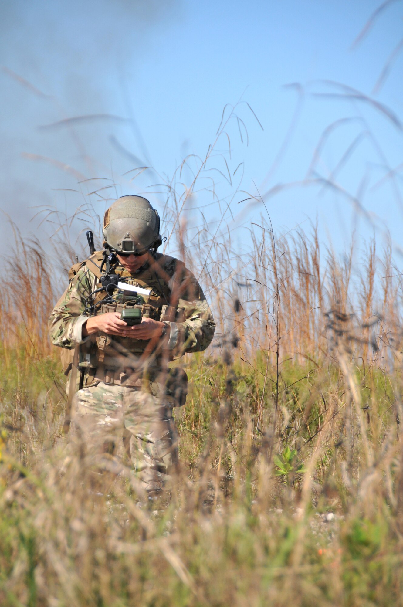 A member from the from the 147th Reconnaissance Wing Air Support Operations Squadron checks his equipment prior to a close air support training exercise at Avon Park Air Force Range, Fla., to complete required periodic evaluations December 16, 2013. Perfoming exercises at the Florida range allows the airmen to hone the skills to perform their jobs in an environment that allows for the use of live aircraft and munitions to replicate real-life warfighting scenarios.