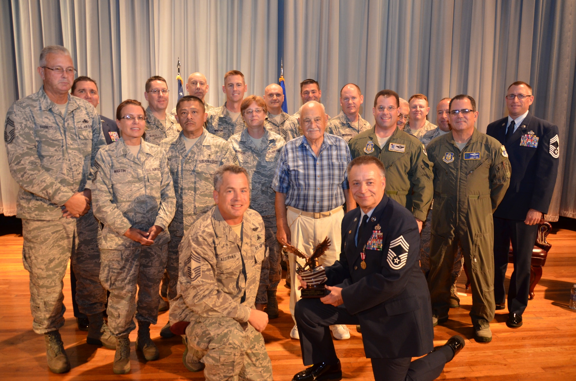 Chief Master Sgt. Randall Becker (center right) poses with the chiefs from throughout the 920th Rescue Wing after being presented with an award from the Space Coast Chiefs Group. Becker retired from the 920th RQW at Patrick Air Force Base, Fla., on Jan. 11, 2014. (U.S. Air Force photo/Senior Airman Natasha Dowridge)