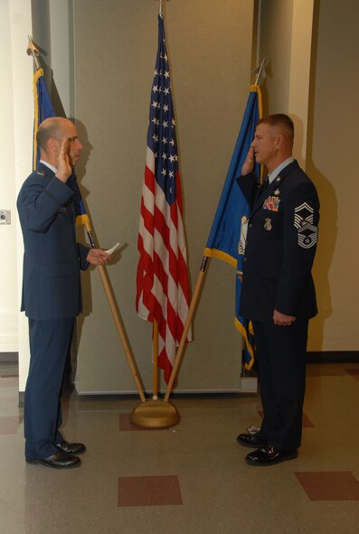 Air National Guard Col. Thomas H. McKenna, commander of the 233d Space Group, administers the Oath of Enlistment to newly appointed, Chief Master Sgt. Jason Ervin during his promotion ceremony at Greeley Air National Guard Station, Colo., Jan. 11, 2014. Ervin will operate as Chief to the 233d Security Forces Squadron, a subordinate unit of the 233d Space Group. (Air National Guard photo by Senior Airman Michelle Y. Alvarez-Rea)