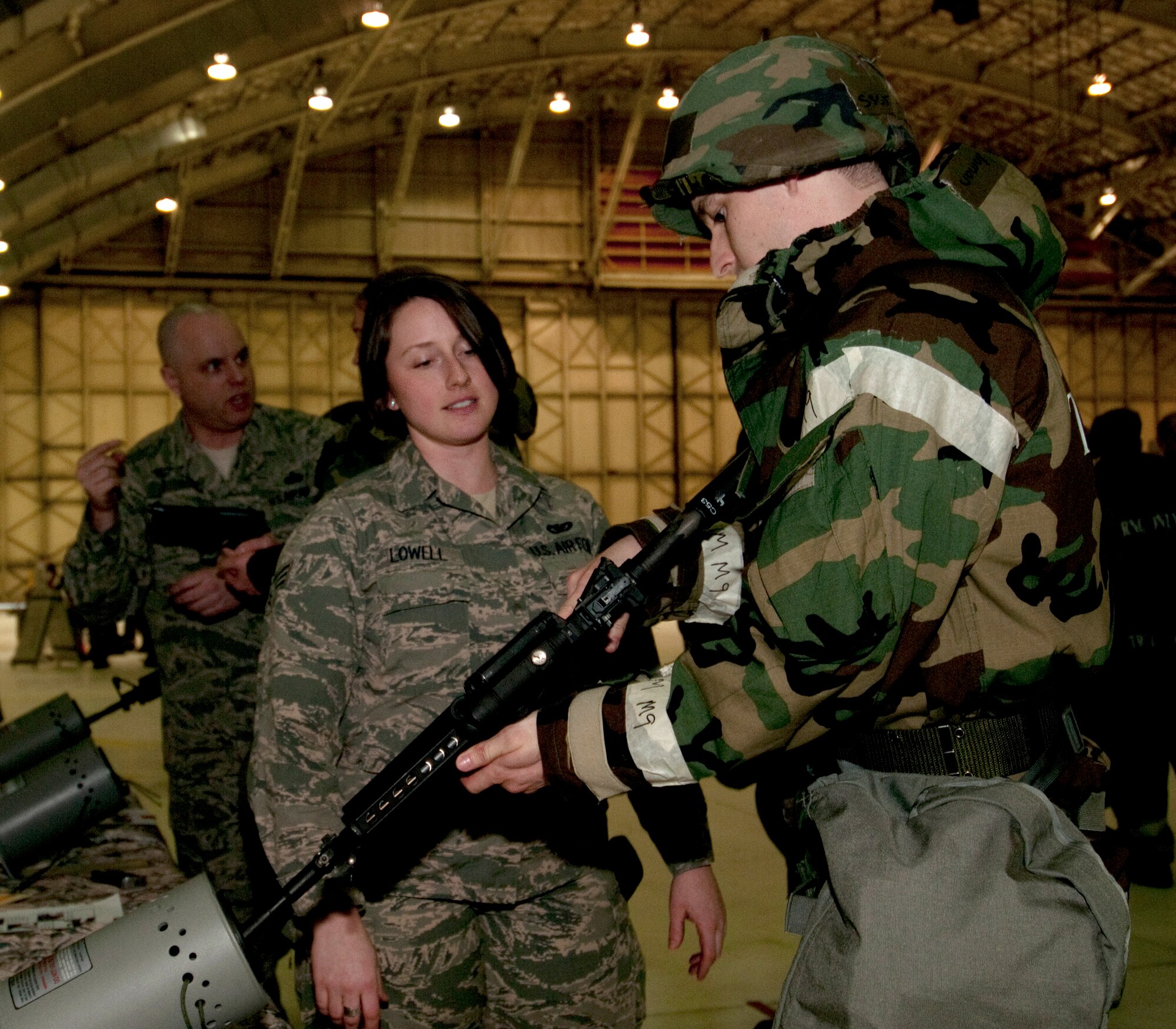 JOINT BASE ELMENDORF-RICHARDSON, Alaska -- Senior Airman Whitney Lowell, a security forces fire team member with the Alaska Air National Guard’s 176th Security Forces Squadron, explains weapons-clearing and handling procedures at a training event here Jan. 10, 2014. Members of the squadron’s parent unit, the 176th Wing, were undergoing the training in preparation for an upcoming inspection. National Guard photo by Tech. Sgt. Jennifer Theulen